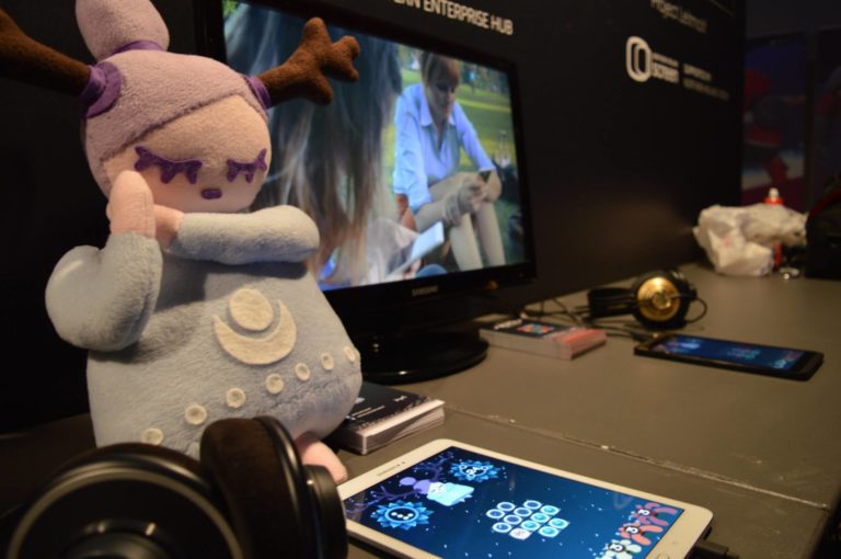 A photo of a Ruya plushie with Miracle Tea participating in Tranzfuser in 2016 for their game Ruya. They were the first people to win this programme.